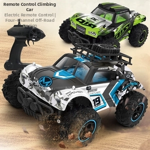 Action shot of blue RC crawler racing on desert sand dunes with dynamic dust effects