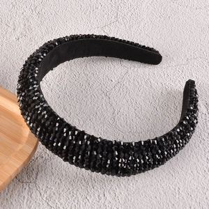 Close-up of luxury black beaded sponge headband with sparkling rhinestones detail