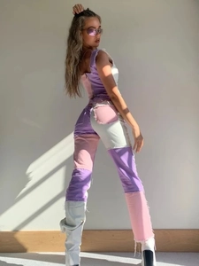 Detail of slim fit patchwork denim vest and pants in purple pink white with frayed edges