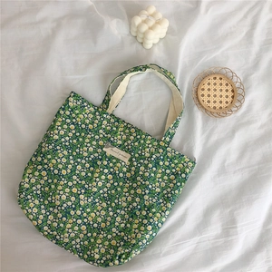Detail of floral cotton handbag with Animal Pattern label on white textured background