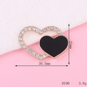 Detail of 21mm gold-plated heart charm with black inlay and clear rhinestones