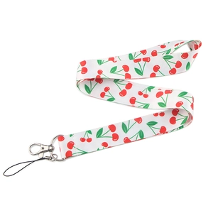 Detail of white fruit lanyard with red cherry patterns and durable metal lobster clasp