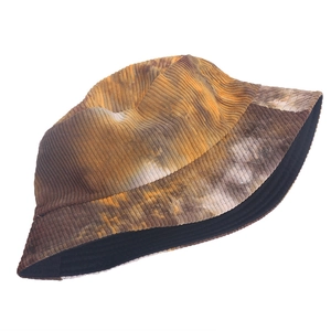 Detailed texture of tie-dye corduroy bucket hat in earthy tones for autumn winter style