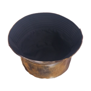 Detail shot of tie-dye corduroy bucket hat interior with black lining and soft texture