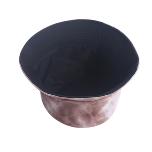 Detail view of tie-dye corduroy bucket hat showing coffee brown texture and black inner lining