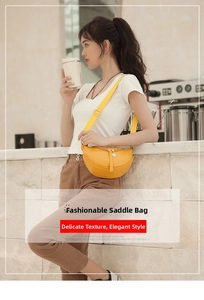 Detail of yellow crocodile embossed crescent saddle bag with adjustable shoulder strap