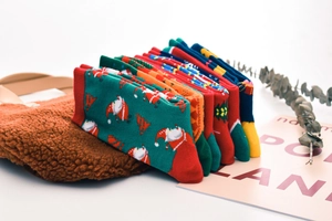 Cute Christmas cotton mid-tube socks featuring Santa and tree patterns for festive holiday wear.