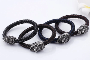 Detailed view of woven leather bracelets with silver lion head clasps in four colors