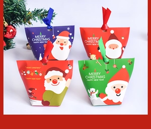 Detail of Christmas pillow gift boxes with silk ribbons and Santa Claus patterns