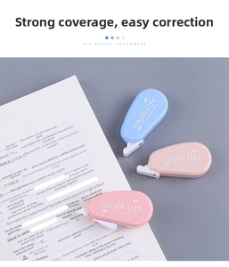 Close-up of Morandi blue and pink correction tape on a notebook for school and office use