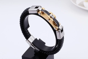 Detail of men's leather bracelet with gold stainless steel and carbon fiber inlay