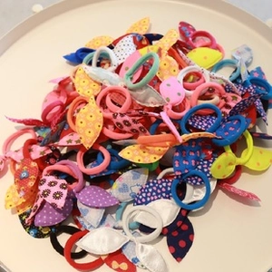 Close-up of assorted colorful elastic hair bands with diverse fabric floral patterns