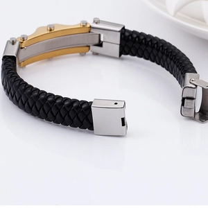 Men's black braided leather bracelet featuring a gold and silver magnetic steel clasp