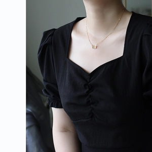 Close-up of 18K gold plated butterfly pendant with zircon crystals on woman's neckline