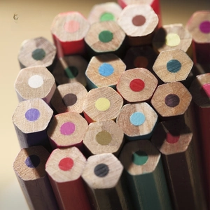 Macro view of 72 professional oil-based colored pencils with hexagonal wooden barrels