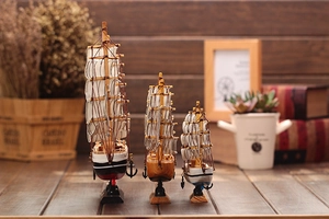 Three Mediterranean wooden sailboat models with canvas sails and detailed ropes for home decor
