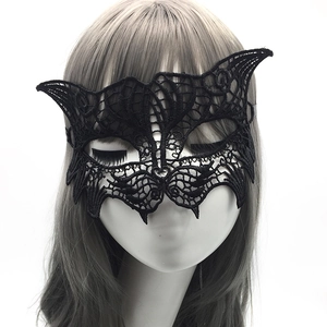 Macro detail of black lace masquerade mask with cat ears on a mannequin model