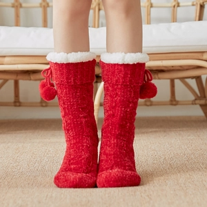 Red thermal knit floor socks with plush cuffs and pom-poms for cozy indoor winter wear