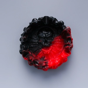Top view of a red and black skull resin mold with gothic wave texture and central skull relief