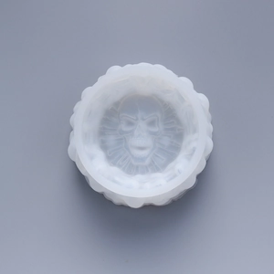 Macro detail of a wave-edged silicone mold with a skull relief for DIY resin casting