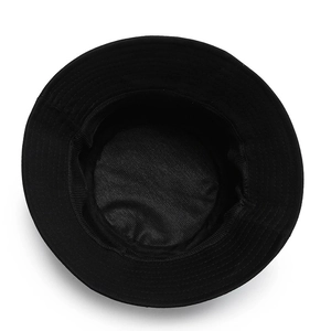 Top-down view of a black chic bucket hat with subtle fabric texture on white background