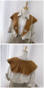 Detail of a brown knitted fake collar featuring a grey heart pattern and dual-sided design