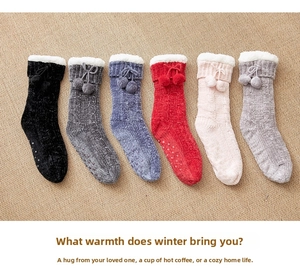 Detail of anti-slip rubber dots on thick fleece floor socks with cute pom-pom ties