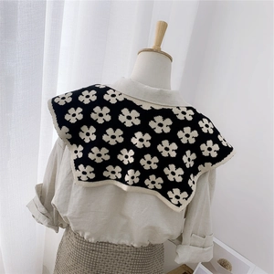 Knitted double-sided floral shawl collar scarf in black and white shown from the back
