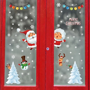 Christmas window decals with Santa, snowman and reindeer on glass for festive decor