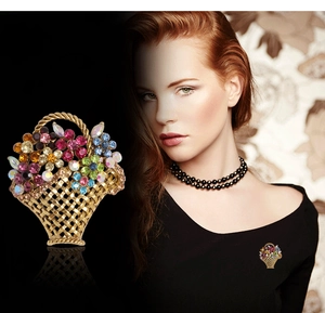 Macro detail of a golden flower basket brooch with colorful crystals and model view