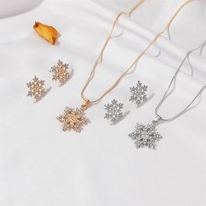 Details des Schneeflocken Schmucksets mit Kristallen auf weißem Satin Hintergrund