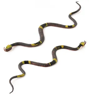 Macro shot of realistic snake models with yellow ring patterns and detailed scales