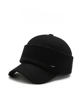 Detail of winter thermal hat showing black knit texture and silver metal side plate
