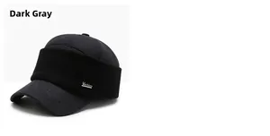 Detailed view of dark grey winter cap with knitted ear flaps and metal side emblem