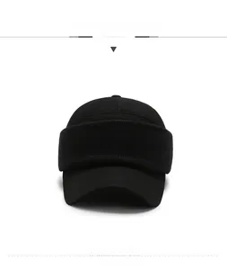 Detail of winter baseball cap featuring foldable knitted ear flaps and metal logo plaque