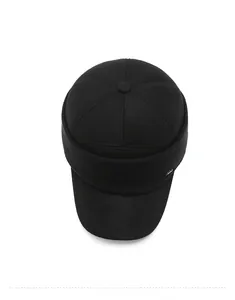 Detail view of winter hat showing textured wool fabric and ribbed knit ear flaps in black