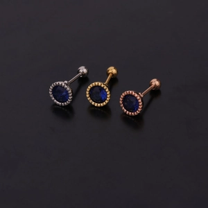 Detailed macro view of sapphire screw back earrings in silver, gold, and rose gold finishes