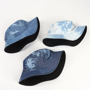 Tie-dye cotton bucket hats for women in blue ink patterns with reversible black lining