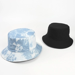 Detail of blue tie-dye and solid black cotton bucket hats with premium stitching