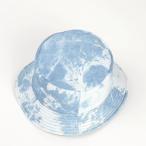 Detailed view of tie-dye bucket hat stitching and denim blue cotton fabric texture