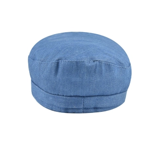 Detailed close-up of a blue denim flat top military cap with reinforced stitching