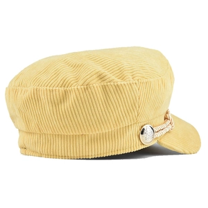 Detail view of yellow corduroy newsboy cap with silver button and braided strap