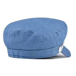 Detail of blue corduroy octagonal cap showing metal button and braided decorative rope