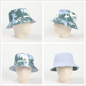 Reversible tie-dye bucket hat in blue and green with a solid light blue inner lining
