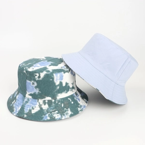 Detail of a tie-dye bucket hat and light blue sun hat with flat top and wide brim design