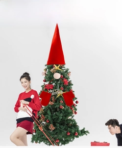 Festive Santa-themed Christmas tree topper set with red pointed hat and Merry Christmas sign