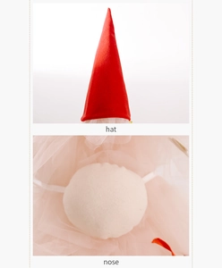 Detail of red fabric gnome hat and round beige nose with pink mesh for Xmas tree topper