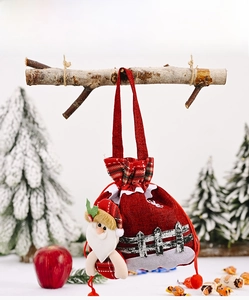 Detail of red burlap Christmas gift bag with 3D Santa Claus doll and drawstring design