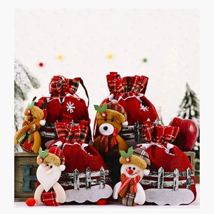 Linen Christmas drawstring gift bags featuring Santa, snowman, and reindeer characters
