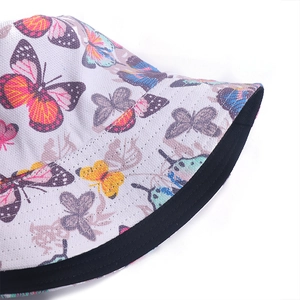 Detailed view of colorful butterfly patterns and stitching on the bucket hat fabric